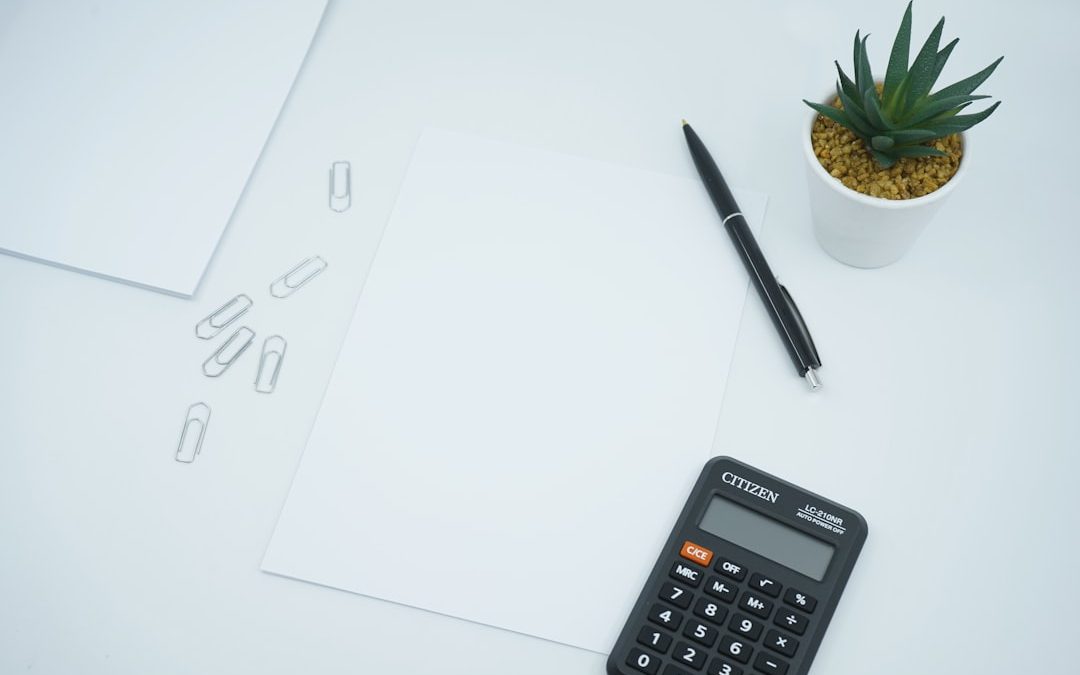 Calculator and notepad on a desk representing pricing